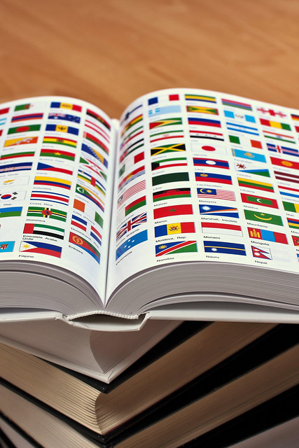 It is opened, showing two pages with the world flags and the names of the 