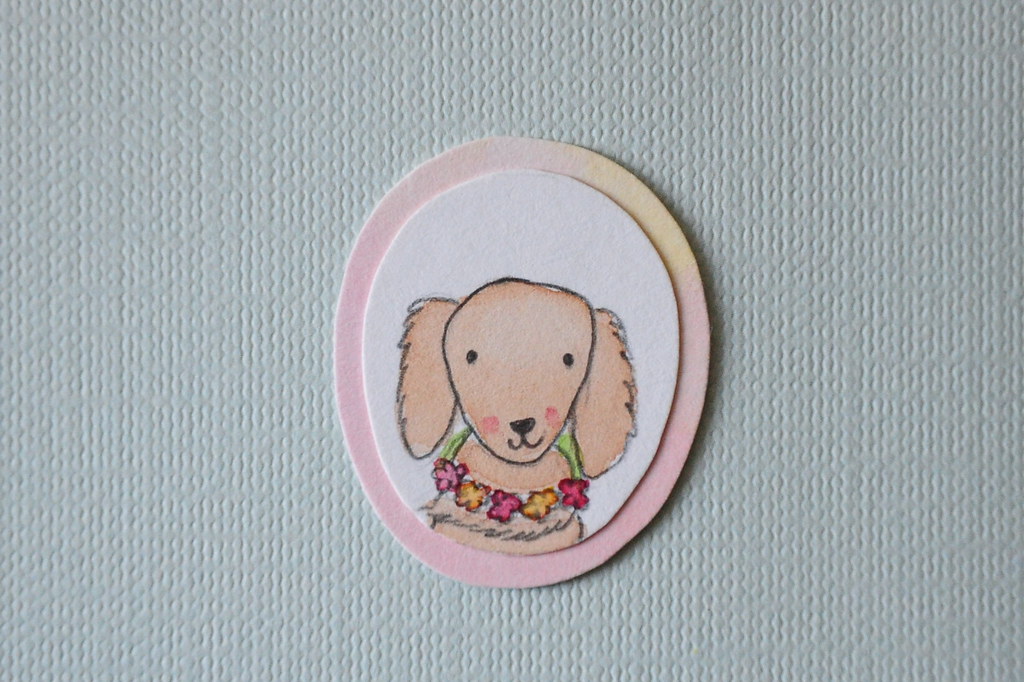 Brooch of a tiny long-haired daschund wearing a flower garland