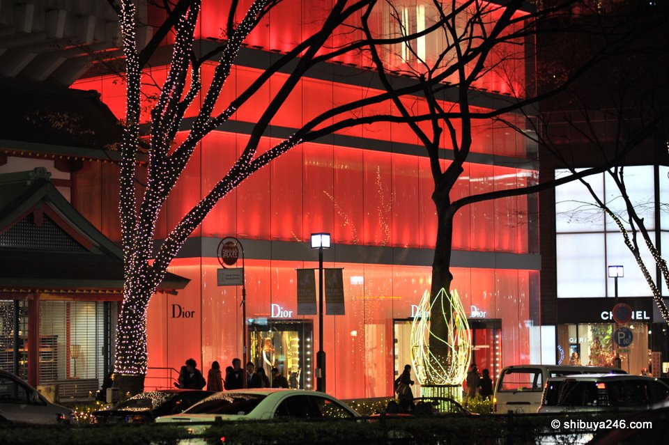 The Dior red building glowing in the night shadows.