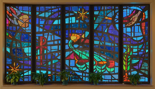Immacolata Roman Catholic Church, in Richmond Heights, Missouri, USA - stained glass window in narthex with symbols of bapism and the Holy Spirit