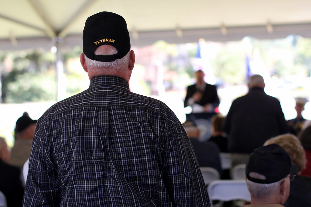 A veteran stands to be recognized for his service