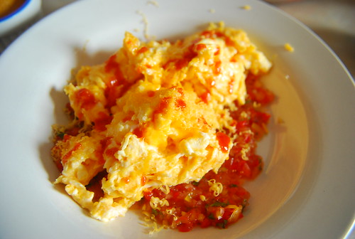 Scrambled eggs on fresh salsa with a bit of cheddar