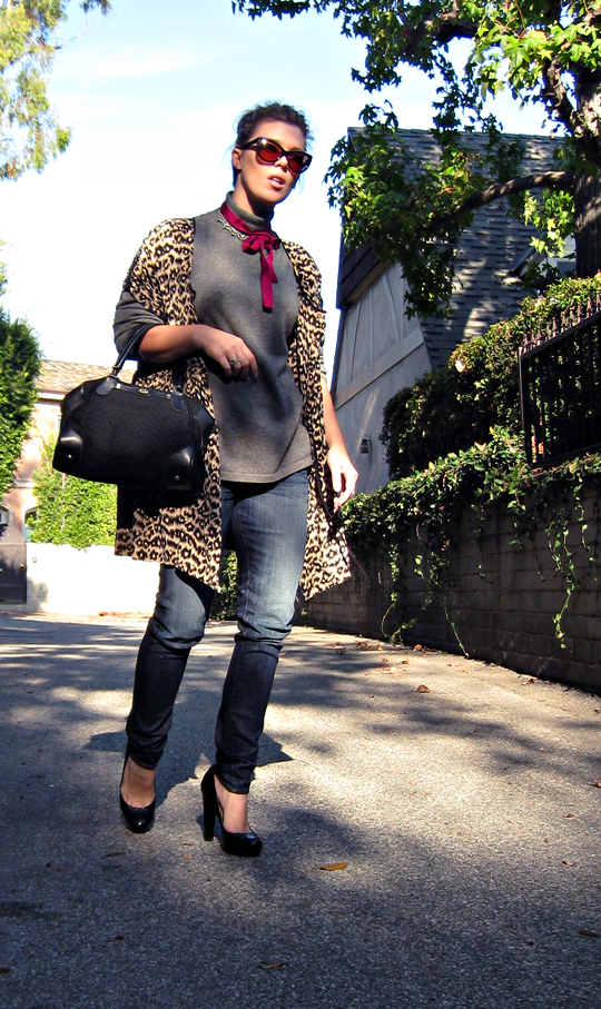 street style+la style+leopard print dress as jacket over jeans and a sweater+sharp