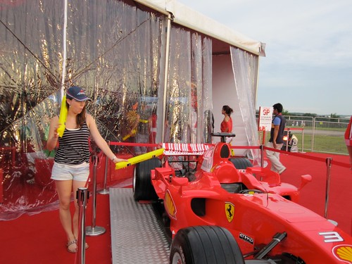 The Ferrari VIP lounge area with a shiny red car oooo