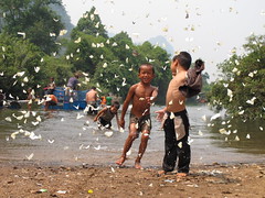 Kids and butterflies in Tha Khaek - along Road 12