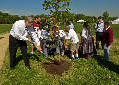 Secretary Vilsack and students plant a tree on Arbor Day
