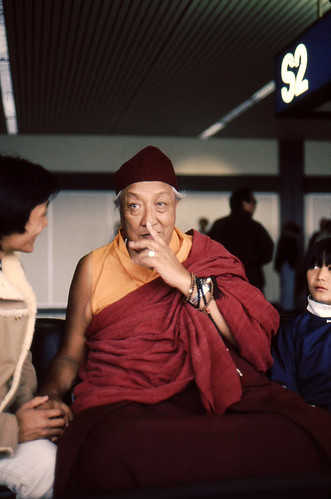 HH Dilgo Khyentse Rinpoche gestures, wearing two malas on his wrist,  chatting with Dhungsey Ani Sakya, and Dhungsey Sadu Sakya, when he visited the USA and  Dharma Center, 1976 SeaTac Airport, Seattle, Washington, USA by Wonderlane