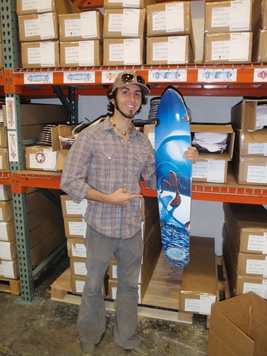 Jay with one of his longboard skateboard models at the warehouse
