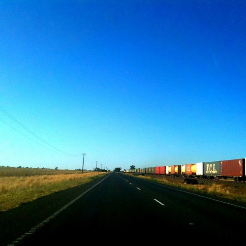 A road, a train, a landscape and a big blue sky