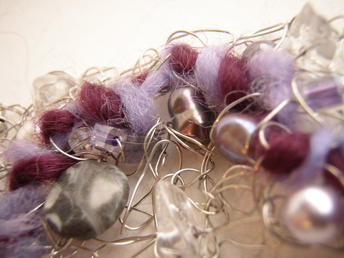 sew; a needle pulling thread
