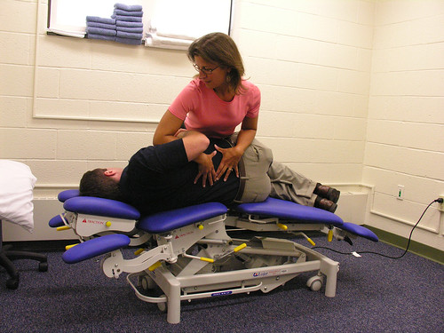 Physical Therapist Laurie Devaney demonstrates how the new mobilization table improves her ability to treat spine injury patients.