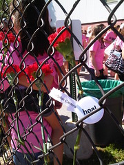 Flowers representing a Juárez victim and Yoko Ono "Heal" Button
