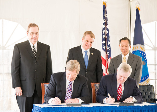 Seated, (L-R) Secretary Tom Vilsack and Secretary Ray Mabus sign the MOU between the Department of Agriculture and the Navy Looking on are Agriculture Under Secretary for Rural Development Dallas Tonsager, Congressman Mike McIntire and Roger Natsuhara, Assistant Secretary of the Navy, Installations and Environment (Acting). 