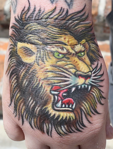 old school lion head tattoo on hand by Hubba Hubba Tattoo