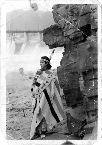 Native American woman, standing alone by cliff by DPL Western History/Genealogy