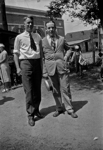 College student William Silverman (at right), standing with his former high school teacher, on the l