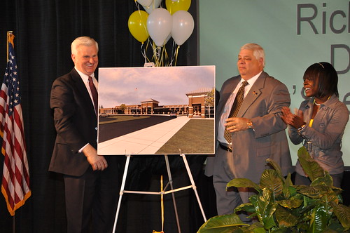 Darryl Rosser, CEO of the Chicago furniture company that supplied new furniture for the J.V. Martin Junior High School, Dillon County school board chairman Richard Schafer and Ty'Sheoma Bethea unveil plans for the new school funded by USDA Rural Development. 