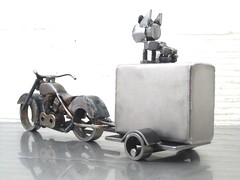 4 Piece Metal Sculpture; A dog, a Harley, a trailer, and a fuel tank