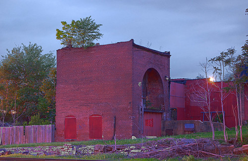 Brick building with large arched doorway, in the Carondelet neighborhood of Saint Louis, Missouri, USA - view at dusk