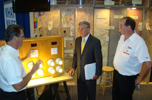 (Left to right)  Bob Dickey Discussing features of the Wall With North Dakota Senator Byron Dorgan. Also shown: Aaron Ridenour at a North Dakota Energy Expo.  