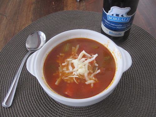 Vegetable soup with cheese and a beer