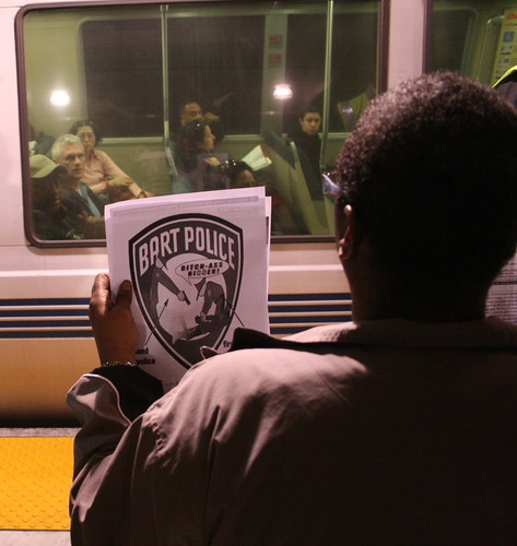 BART protester holds up sign for passengers
