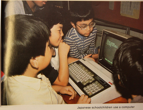 Niños japoneses programando trabajando con un ordenador en los 80
