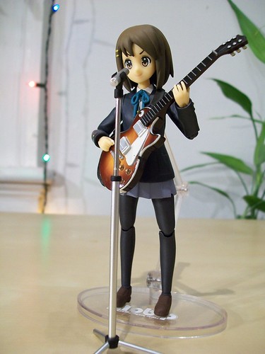 Yui with her guitar and microphone