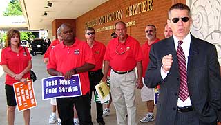CWA District 2 Vice President Ron Collins and CWA members protest Verizon-Frontier deal outside Verizon annual meeting.