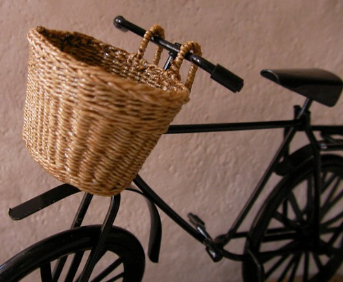 One of a kind, woven bicycle basket in 1:12 scale is hand made by CDHM Artisan Lidi Stroud, IGMA Artisan of Nambucca's Little Shoppe