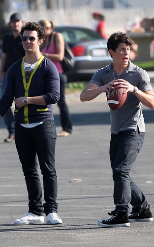 The Jonas Brothers Tossing A Football On Set by spunkransom2705.
