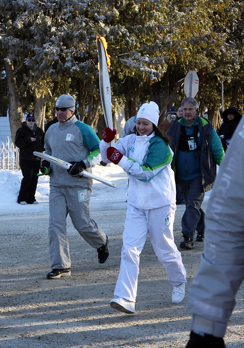 Michelle Arseneault carries the Olympic torch on the final leg of its journey.