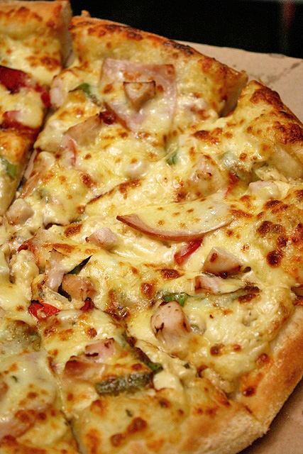 Classy Chic pizza - mozzarella cheese, smoked chicken breast, chicken sausage, green pepper, onion and olives