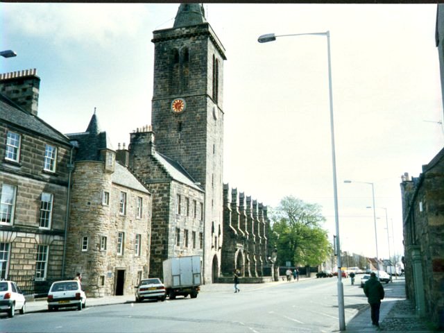 The University Chapel, from 1451

In the cobblestones between the Chapel and the street is an X, marking the spot where Andrew Hamilton and other Hussite heretics were burned before the Reformation. It used to be the custom to avoid stepping on the stones that made up the cross. To the left, beside the lane called Butts Wynd, is the Admirable Crichton's house. Crichton graduated from the University at some very early age, and became Admirable for winning a debate at the University of Paris. He apparently was not as admirable a swordsman as a debater, for he lost a duel in Italy before he was thirty. In my day this house was the Student Union, and is now a dining hall.