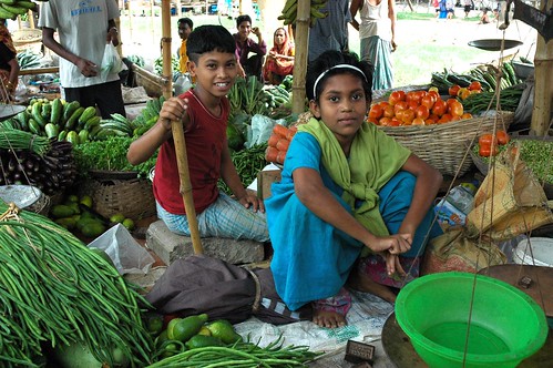 Market vegetable vendors, children, a boy and girl, with scale of plastic and metal, green beans, tomatos, bags, Dhaka, Bangladesh by Wonderlane