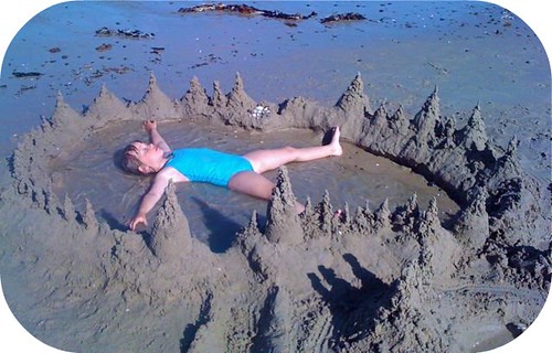floating in the middle of sandcastles at the beach