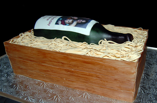Wine bottle in a wooden crate birthday cake side view