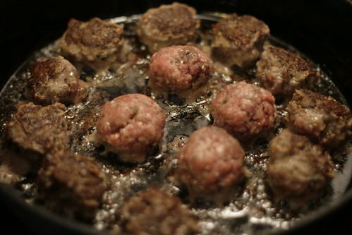 Meatballs cooking in a skillet