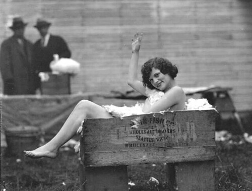Nude girl lounging in a box full of rabbit fur
