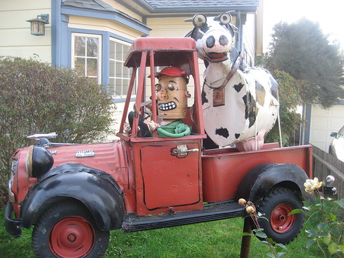 A man and his dog and his cow in his truck