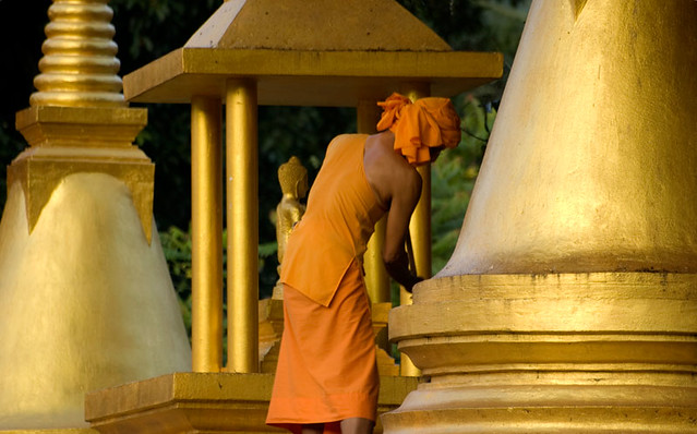 Buddhist monk cleaning Lamai Temple. By Marina Nozyer