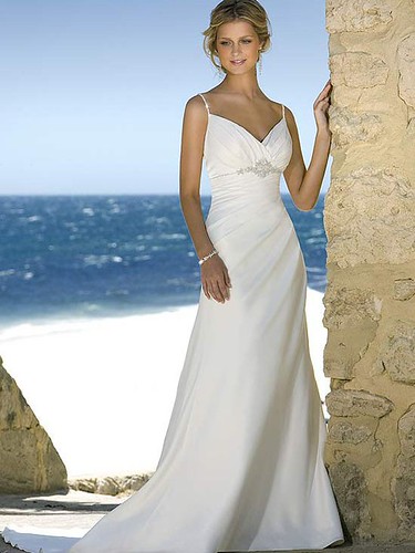 Gown features beaded straps and decorative brooch.