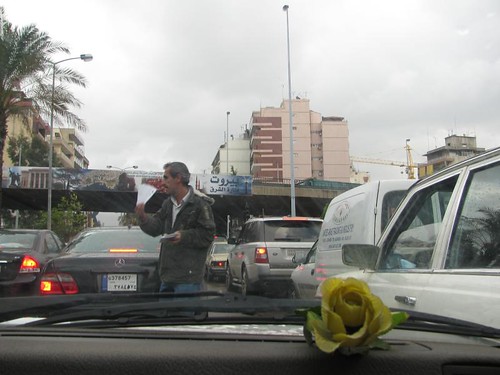 man selling lottery tickets in traffic jam