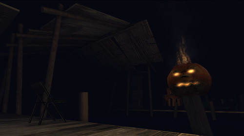 A jack-o-lantern dimly glows in the deep dark of Malady Bog
