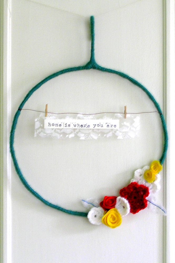 home is where you are - yarn wreath in teal, red, yellow, and white