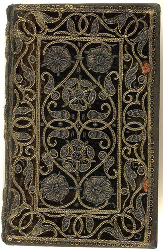 16th century embroidered velvet book with scroll and floral pattern.