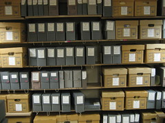 Archival boxes on a range of shelves.