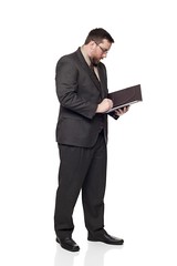 Side view of Caucasian businessman writing on notepad. by dgilder