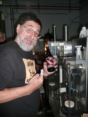 Pete Slosberg, helping out for the day, shows off a finished bottle