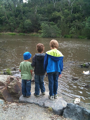 three boys by the river